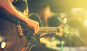 Guitarist on stage for background, soft and blur concept, Vintage color tone style